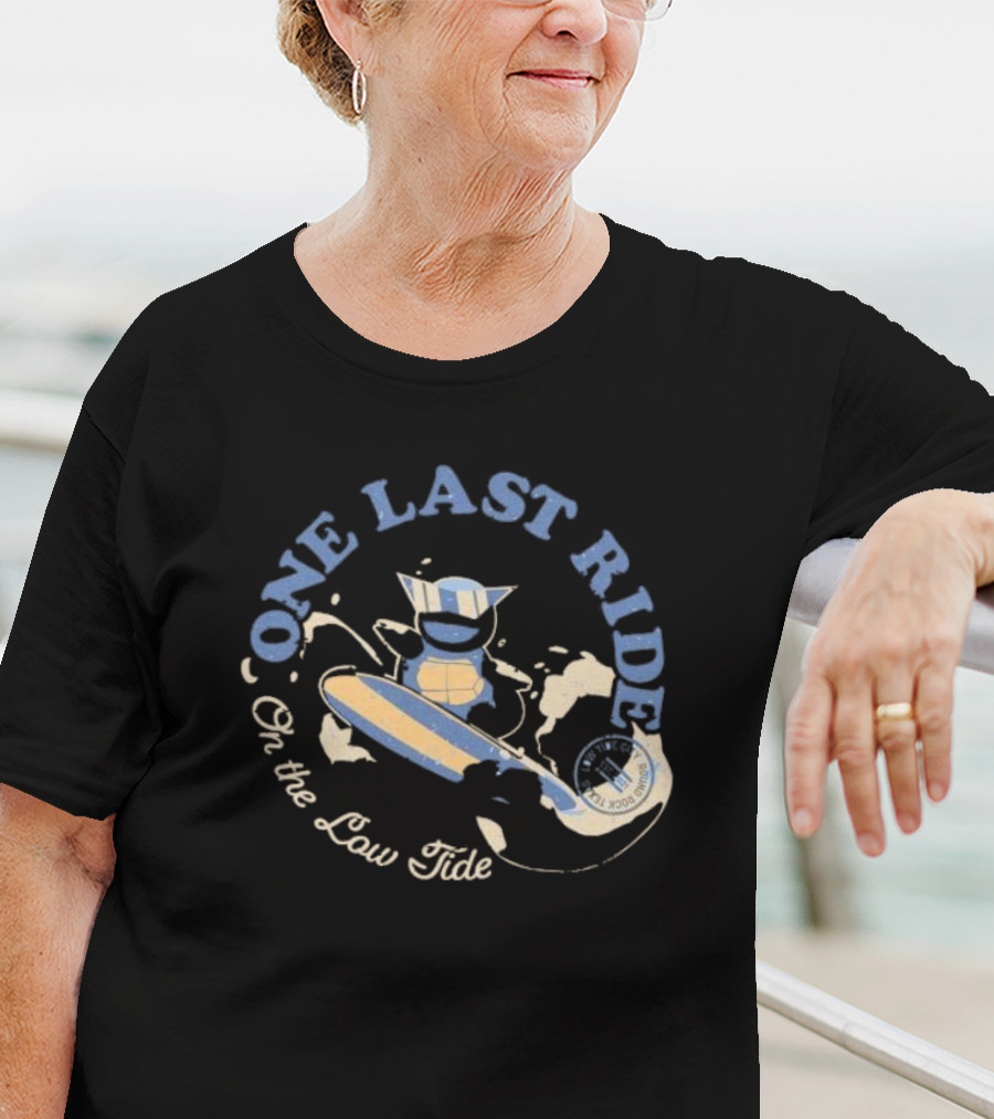 Surfing Adventure With Blue Masked Figure And Iconic Board 'One Last Ride On The Low Tide' T-Shirt